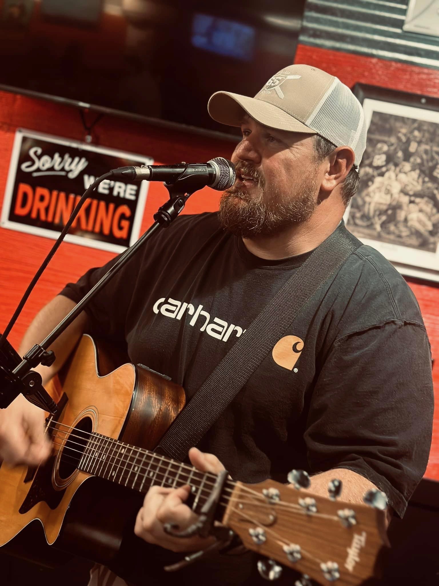 Scotty Sams performing acoustic guitar