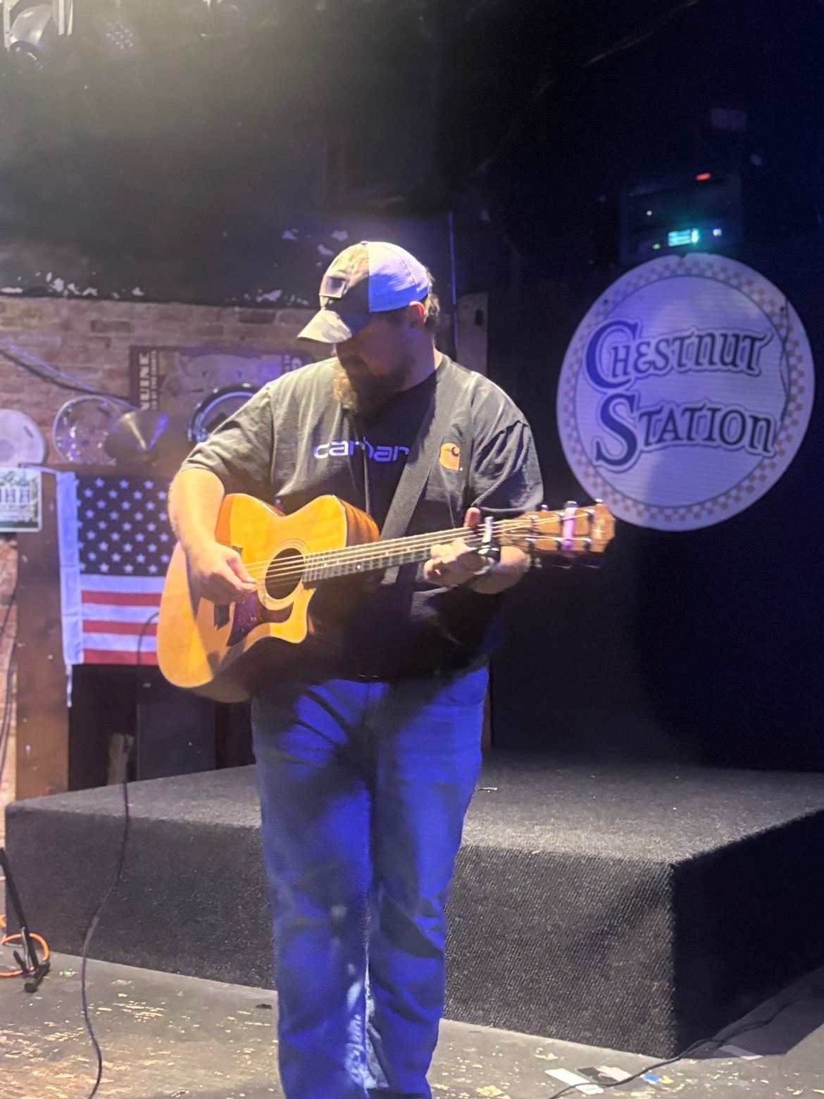 Scotty Sams on stage with acoustic guitar