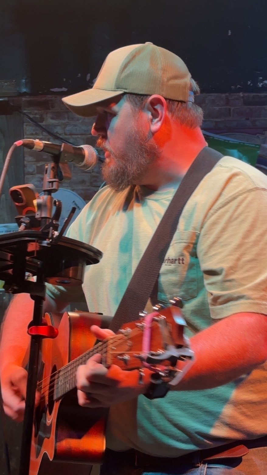 Close-up of Scotty Sams singing and playing guitar