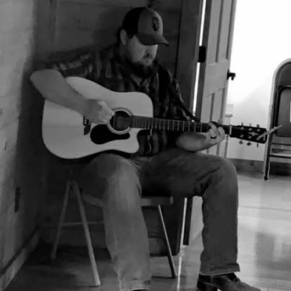 Scotty Sams playing guitar in black and white